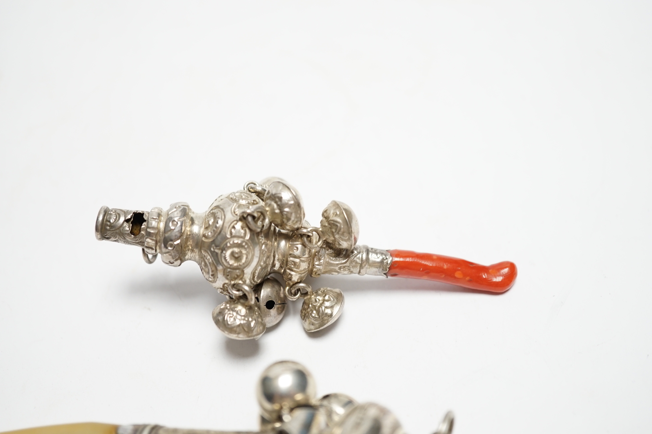 A George III child's silver rattle, with mother of pearl teether, Joseph Wilmore, Birmingham, 1808, 13.5cm and a late Victorian child's silver rattle, with coral teether.